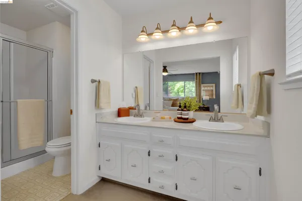 a bathroom with a sink mirror and toilet