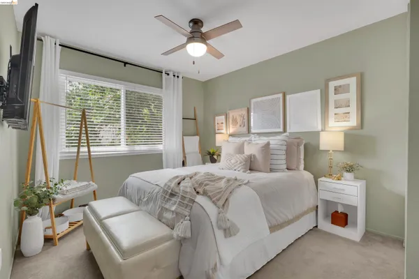 a bedroom with a bed furniture and a large window