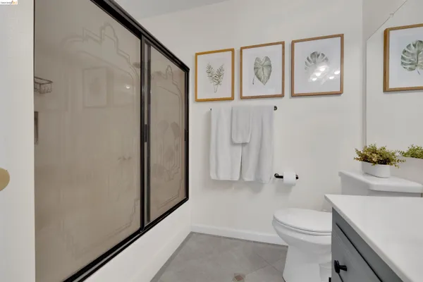 a white toilet sitting next to a bathroom sink