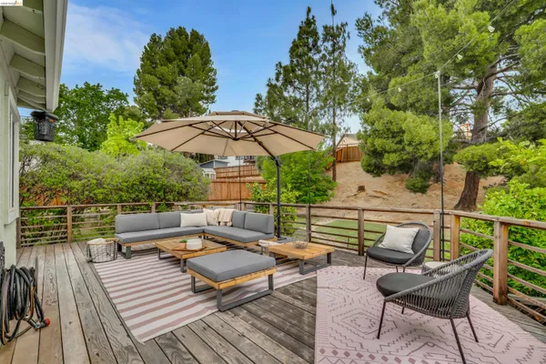an outdoor sitting area with furniture and wooden deck