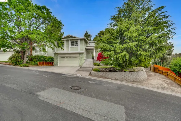 a front view of a house with a yard and a garage