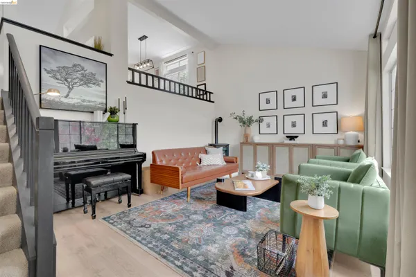 a living room with furniture and a piano