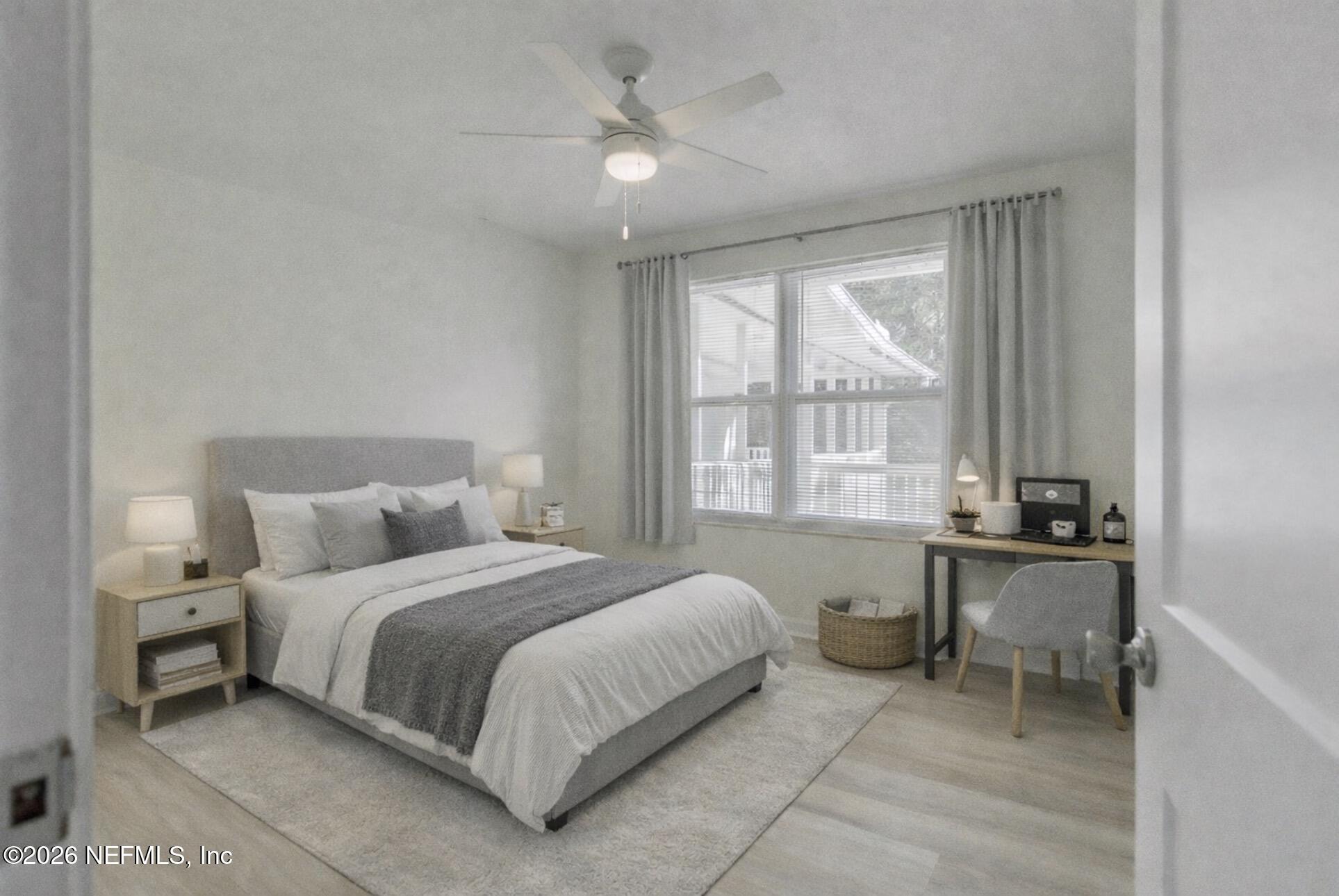 2754 Rainbow Road Jacksonville, FL 32217 - Photo 14 of 25 a bedroom with a bed and a large window