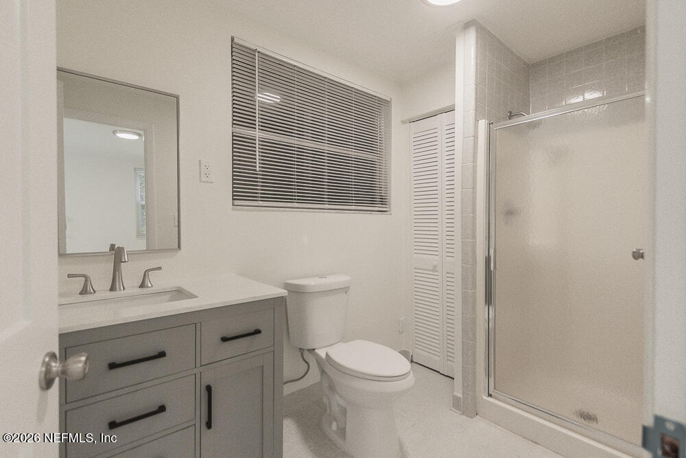 2754 Rainbow Road Jacksonville, FL 32217 - Photo 19 of 25 a bathroom with a sink a toilet and shower