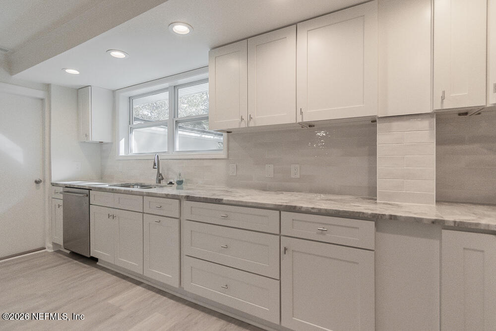 2754 Rainbow Road Jacksonville, FL 32217 - Photo 6 of 25 a kitchen with granite countertop white cabinets and sink