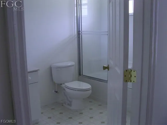 a white toilet sitting next to a shower curtain