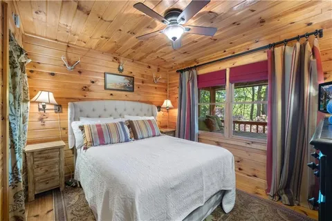 a bedroom with a bed and a large mirror on the dresser