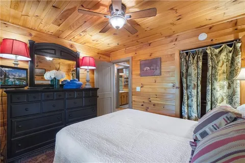 a bedroom with a bed and a book shelf