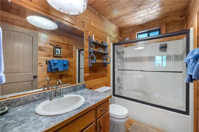 a bathroom with white cabinets and sink