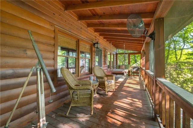 a view of a porch with furniture and yard