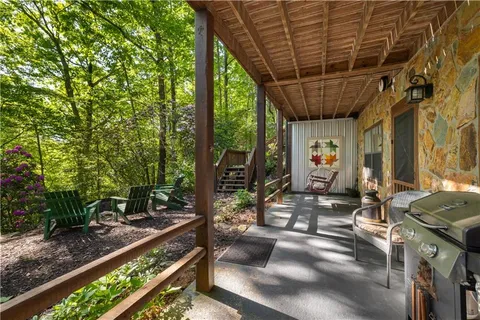 an aerial view of a house with a yard and a large tree