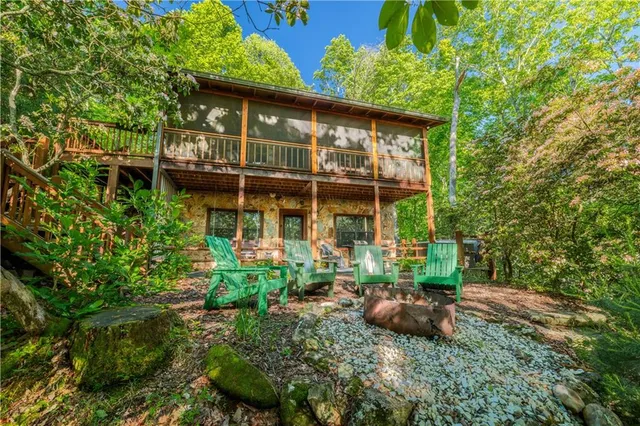 a view of a house with yard and sitting area