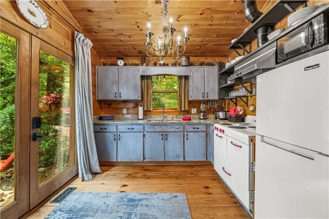 a kitchen with refrigerator and window
