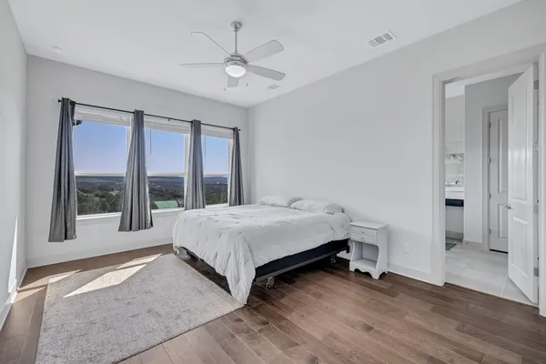 a bedroom with a bed and a large window