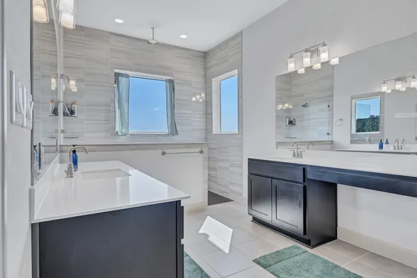 a bathroom with a sink double vanity and a mirror
