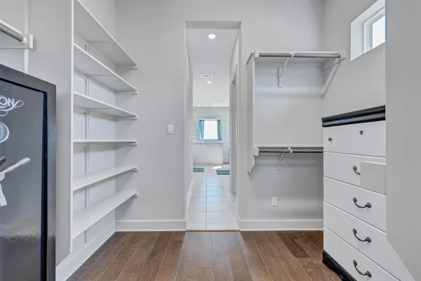 a view of walk in closet with empty racks