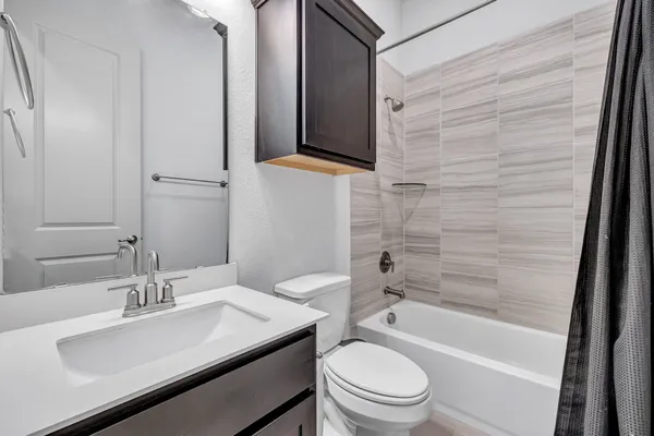 a bathroom with a sink a toilet and bathtub