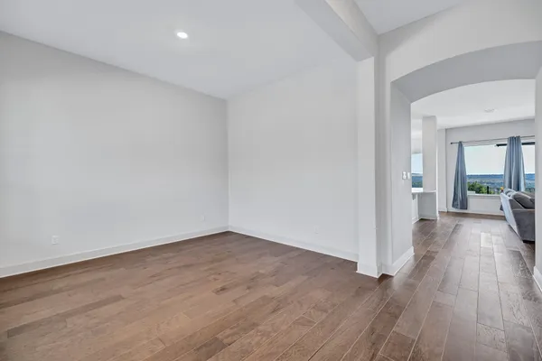 wooden floor in a hall with an empty room