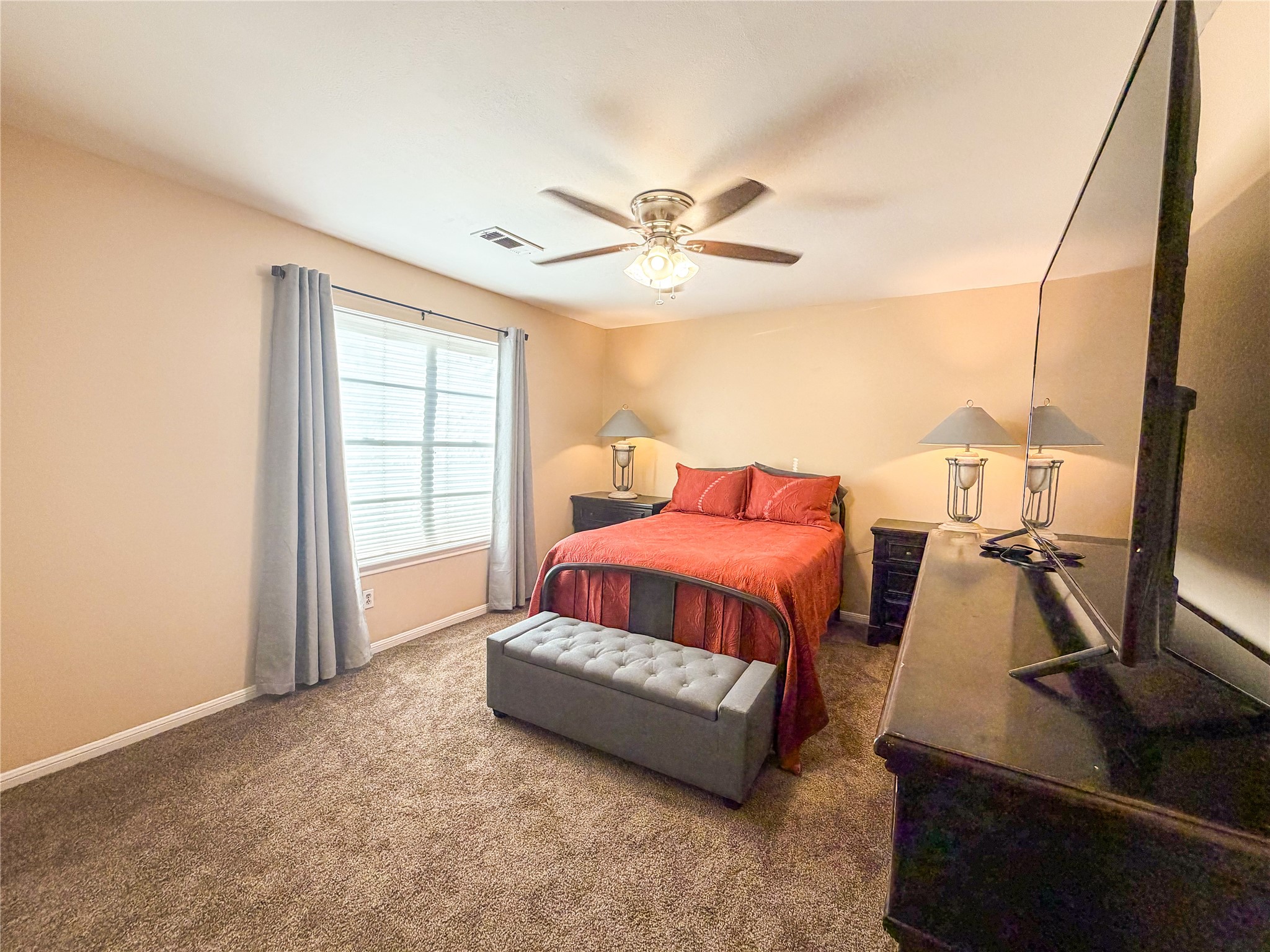 4023 Oxhill Road Spring, TX 77388 - Photo 13 of 18 a spacious bedroom with a bed and wooden floor