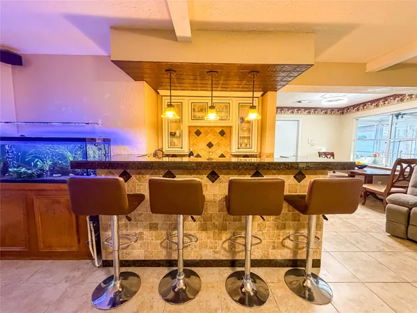 a large kitchen with a table and chairs