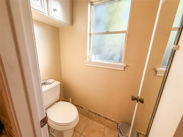 a white toilet sitting next to a sink