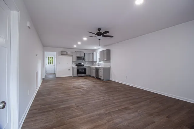 a view of a kitchen with a sink and a refrigerator
