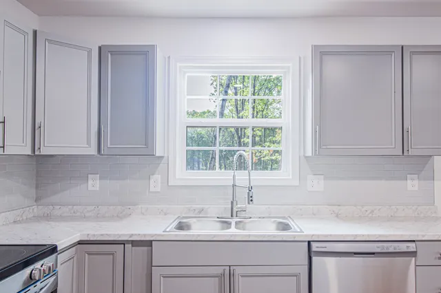 a kitchen with a sink cabinets and window