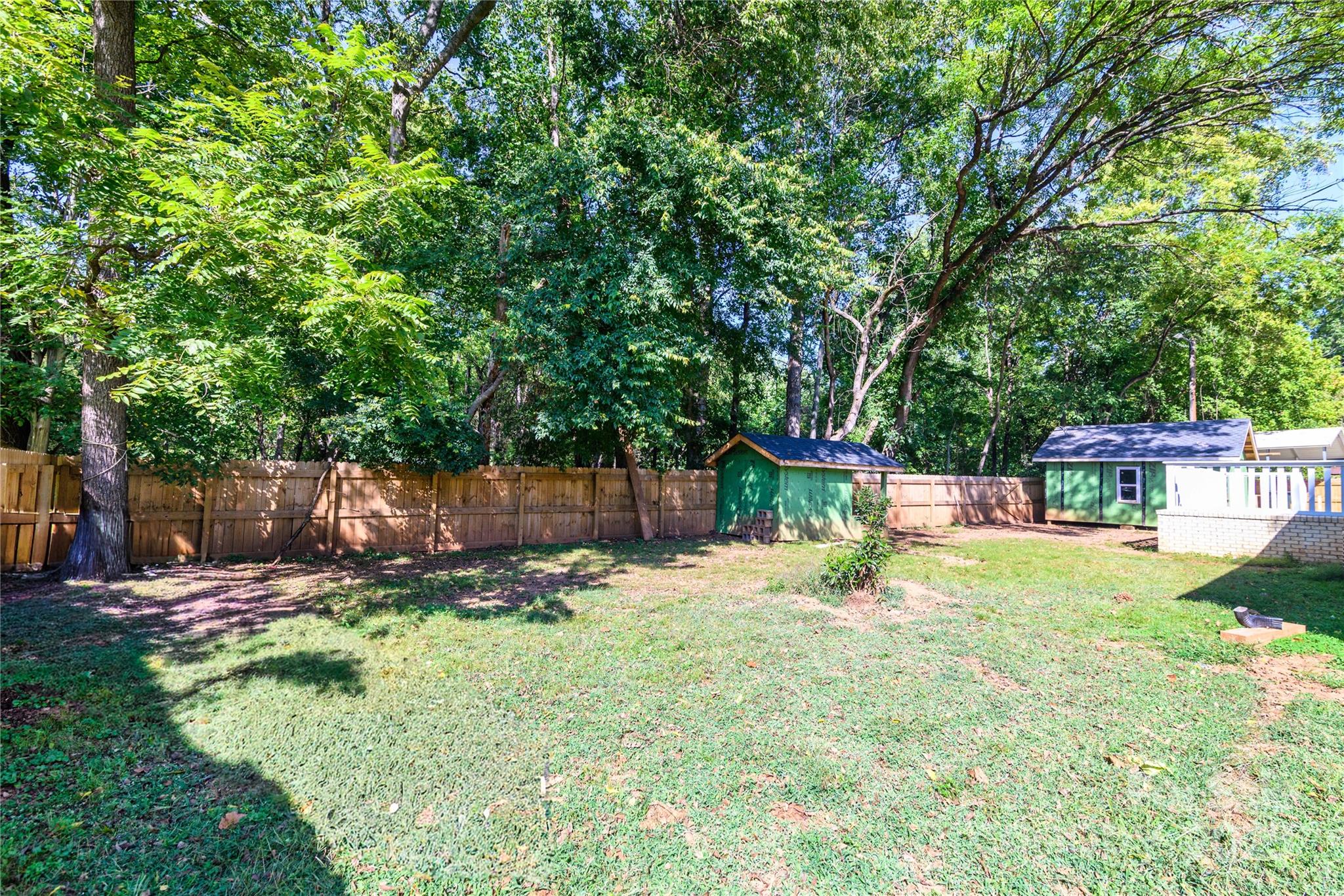 4946 Grand Canyon Road Northwest Concord, NC 28027 - Photo 11 of 40 a view of a backyard with table and chairs under an umbrella
