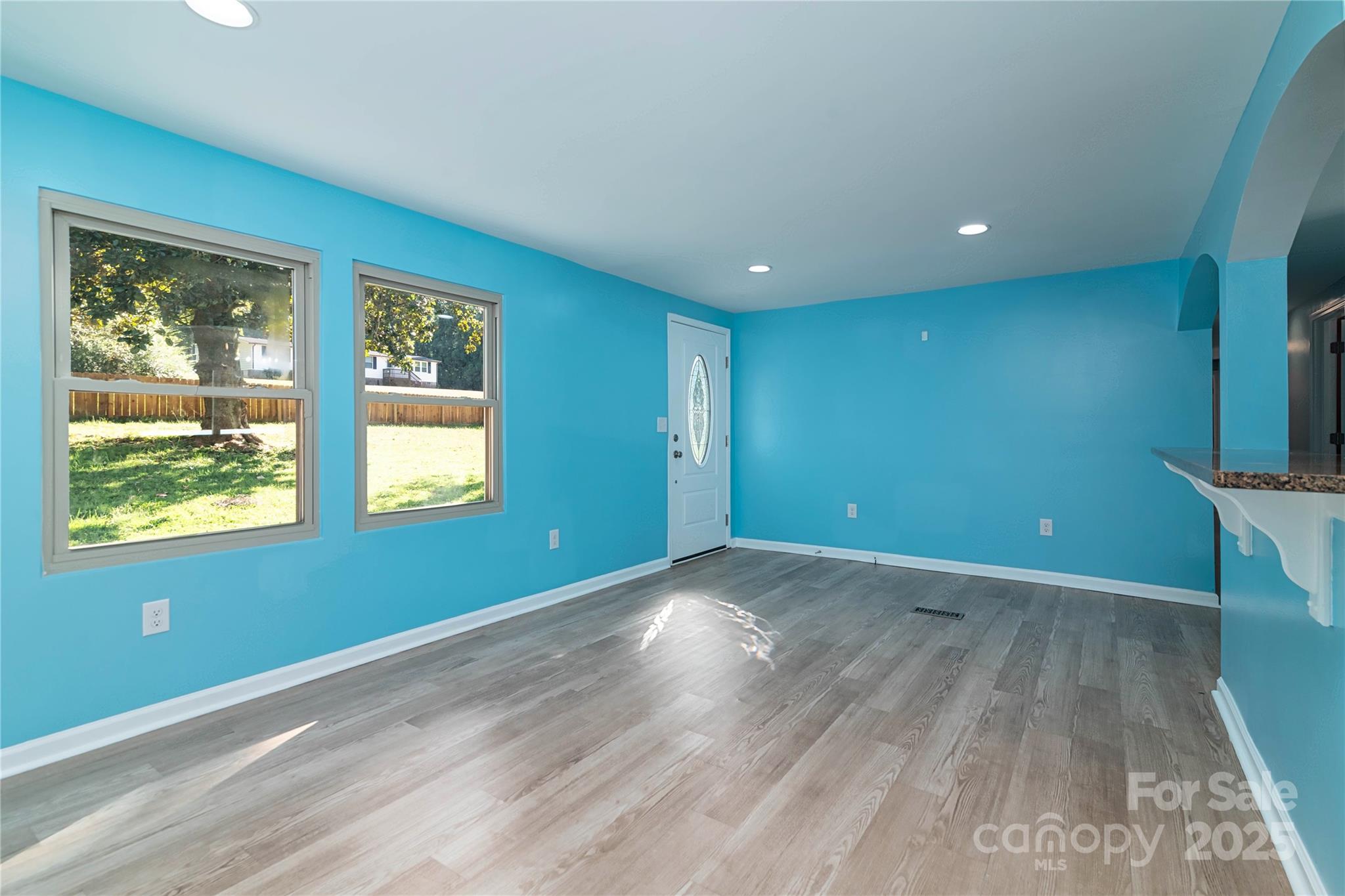 4946 Grand Canyon Road Northwest Concord, NC 28027 - Photo 21 of 40 an empty room with wooden floor and windows