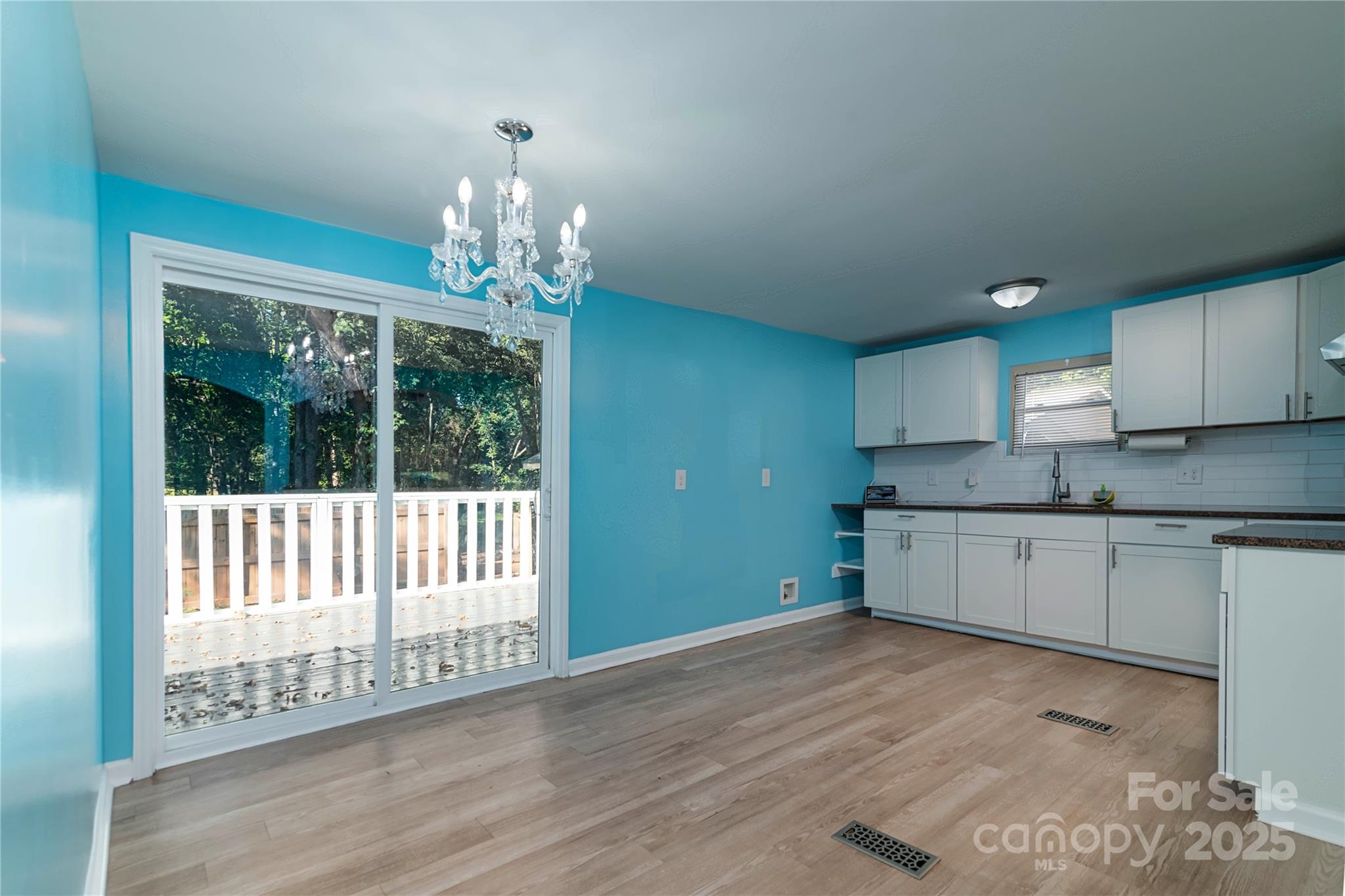 4946 Grand Canyon Road Northwest Concord, NC 28027 - Photo 24 of 40 a open kitchen with granite countertop a stove top oven a sink and dishwasher with wooden floor