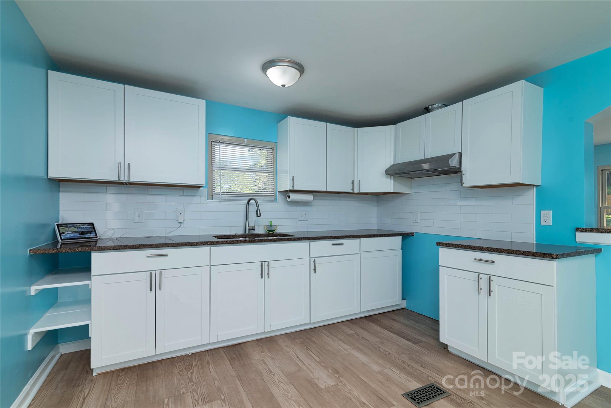 4946 Grand Canyon Road Northwest Concord, NC 28027 - Photo 26 of 40 a kitchen with granite countertop cabinets stainless steel appliances and a sink