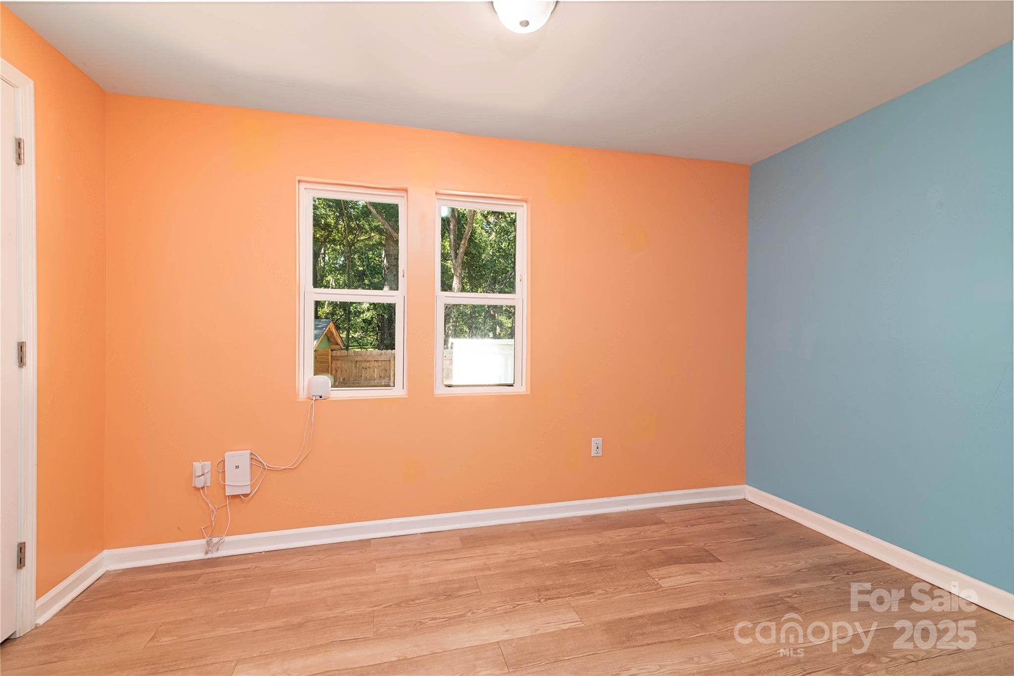 4946 Grand Canyon Road Northwest Concord, NC 28027 - Photo 27 of 40 a view of an empty room with wooden floor and a window