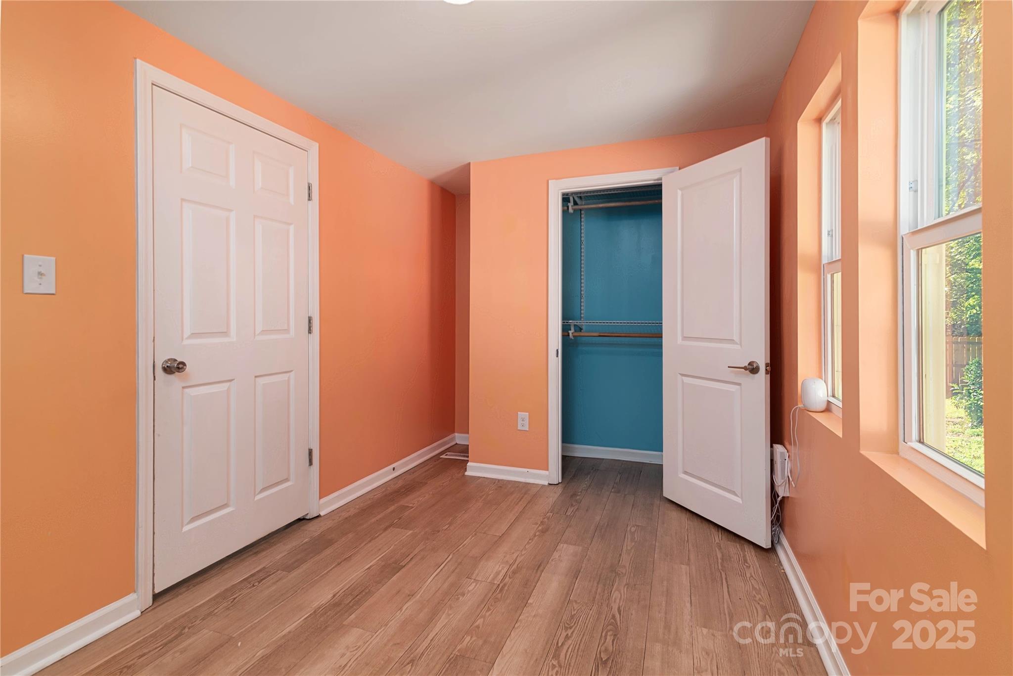 4946 Grand Canyon Road Northwest Concord, NC 28027 - Photo 28 of 40 an empty room with wooden floor and windows