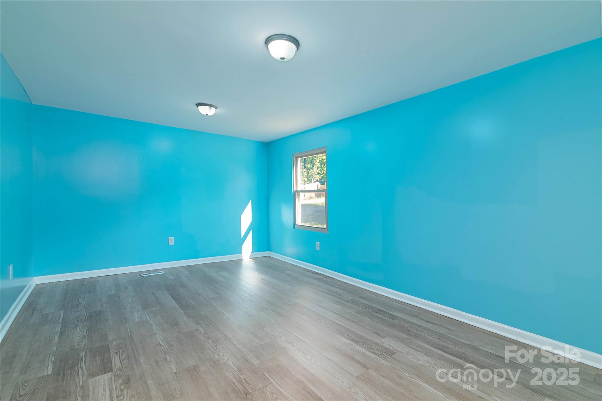 4946 Grand Canyon Road Northwest Concord, NC 28027 - Photo 29 of 40 a view of an empty room with window and wooden floor