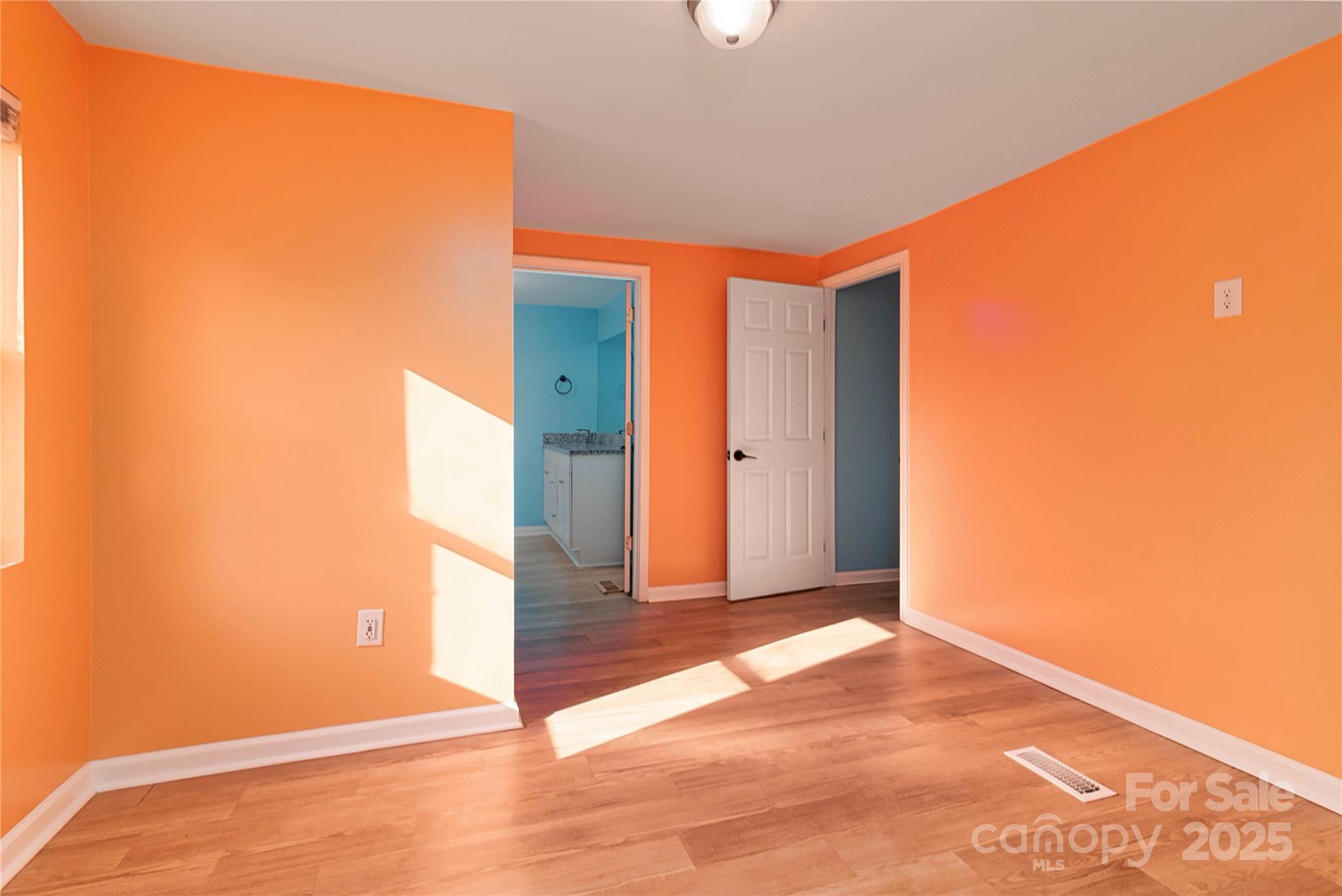 4946 Grand Canyon Road Northwest Concord, NC 28027 - Photo 37 of 40 an empty room with wooden floor and a window