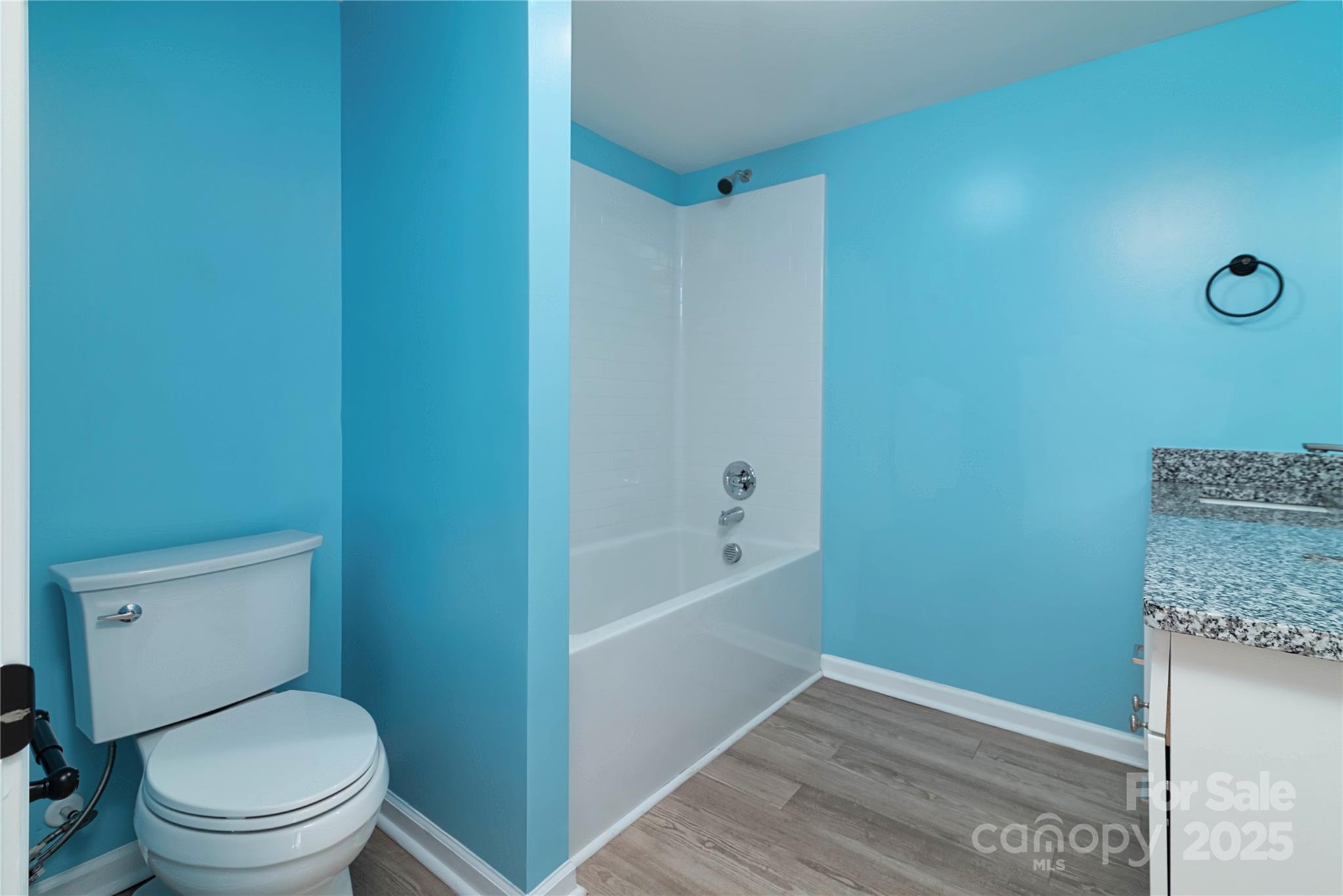 4946 Grand Canyon Road Northwest Concord, NC 28027 - Photo 38 of 40 a bathroom with a granite countertop toilet and a bathtub