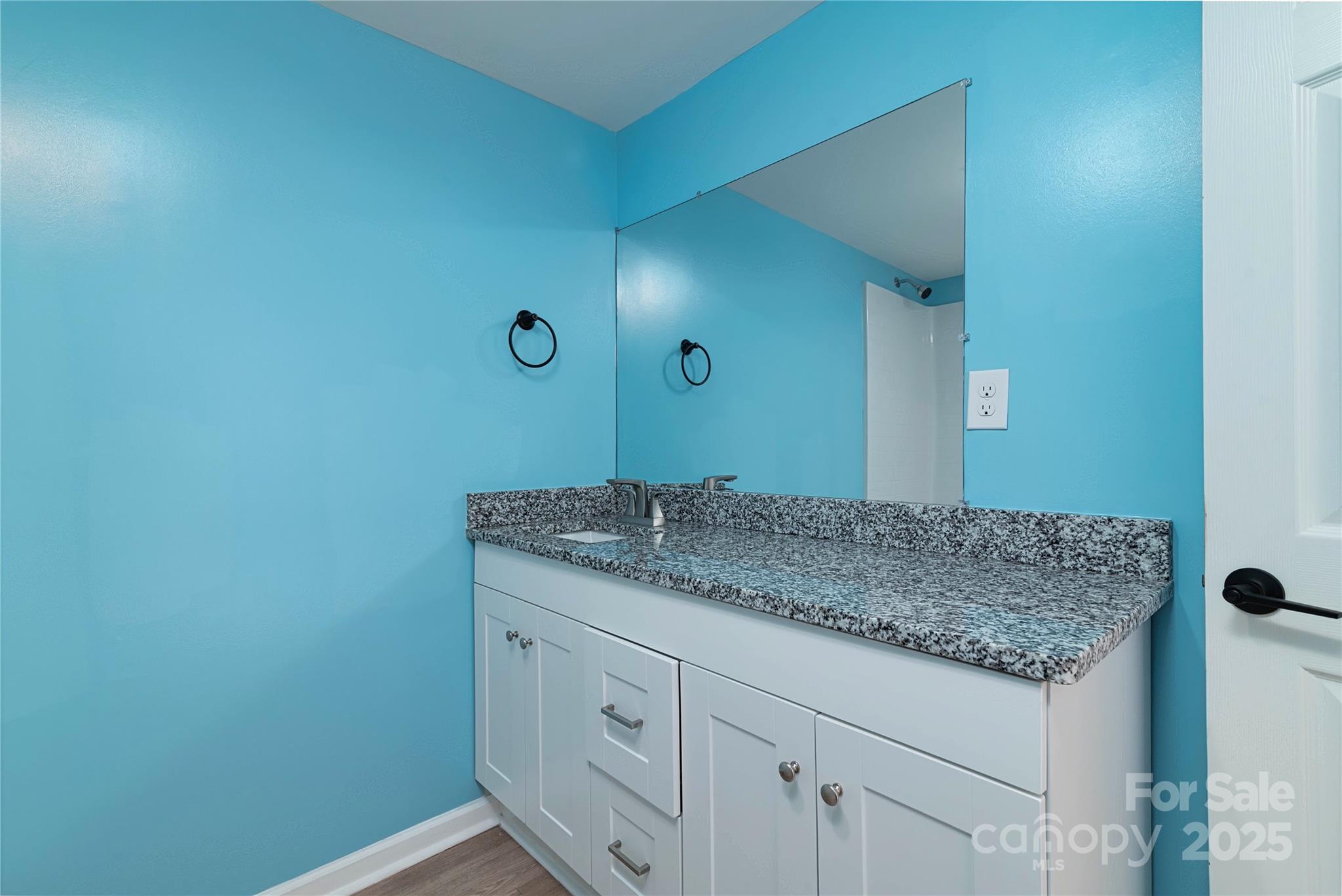 4946 Grand Canyon Road Northwest Concord, NC 28027 - Photo 39 of 40 a bathroom with a granite countertop sink and a mirror