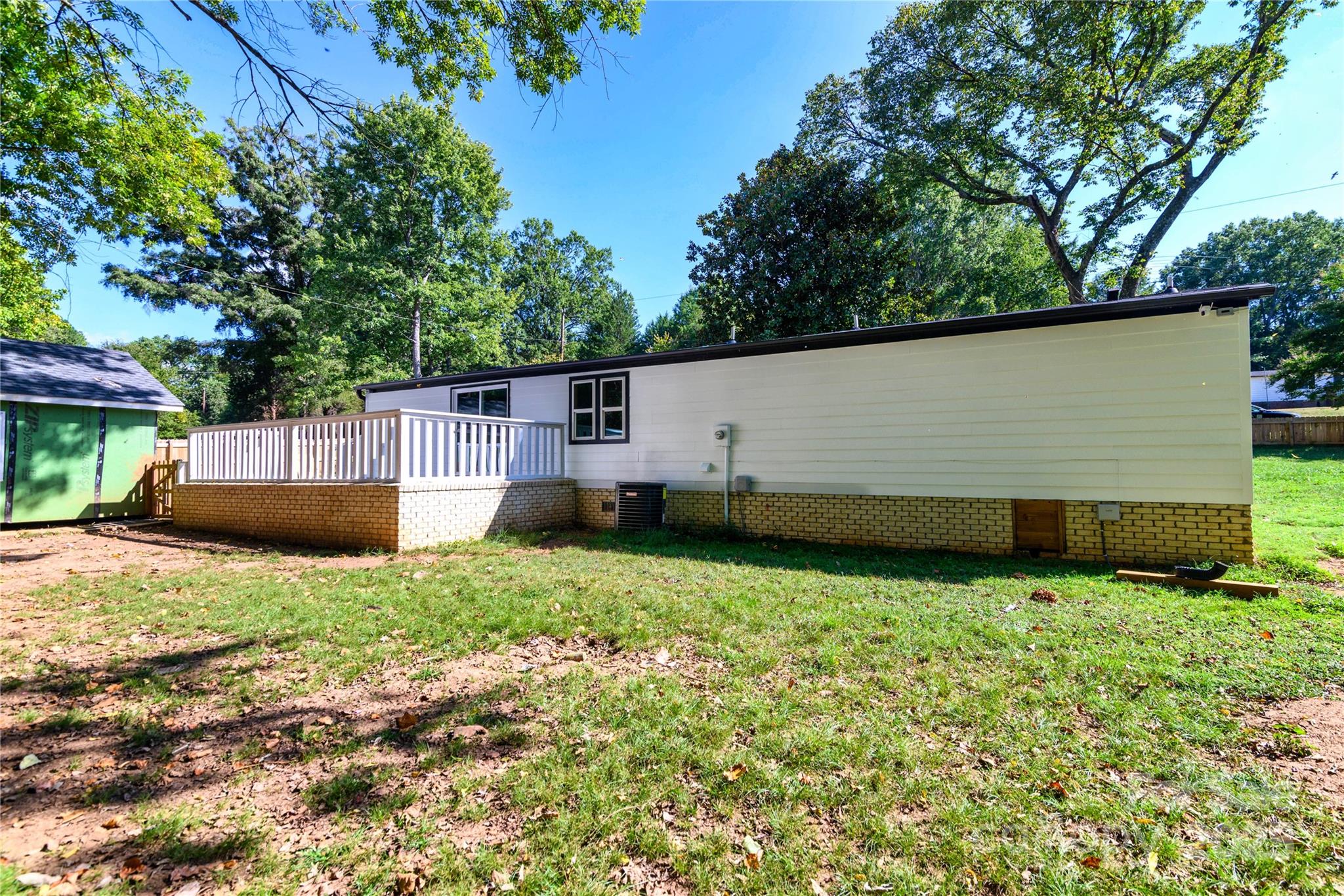 4946 Grand Canyon Road Northwest Concord, NC 28027 - Photo 4 of 40 a view of a backyard with potted plants and large tree