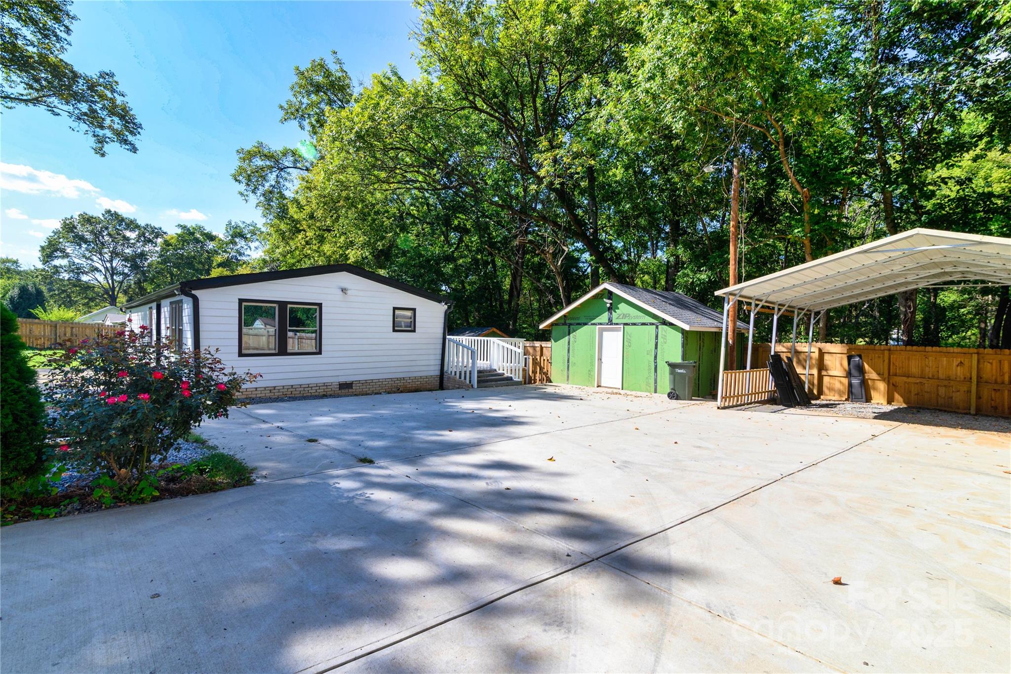 4946 Grand Canyon Road Northwest Concord, NC 28027 - Photo 8 of 40 a front view of a house with a garden
