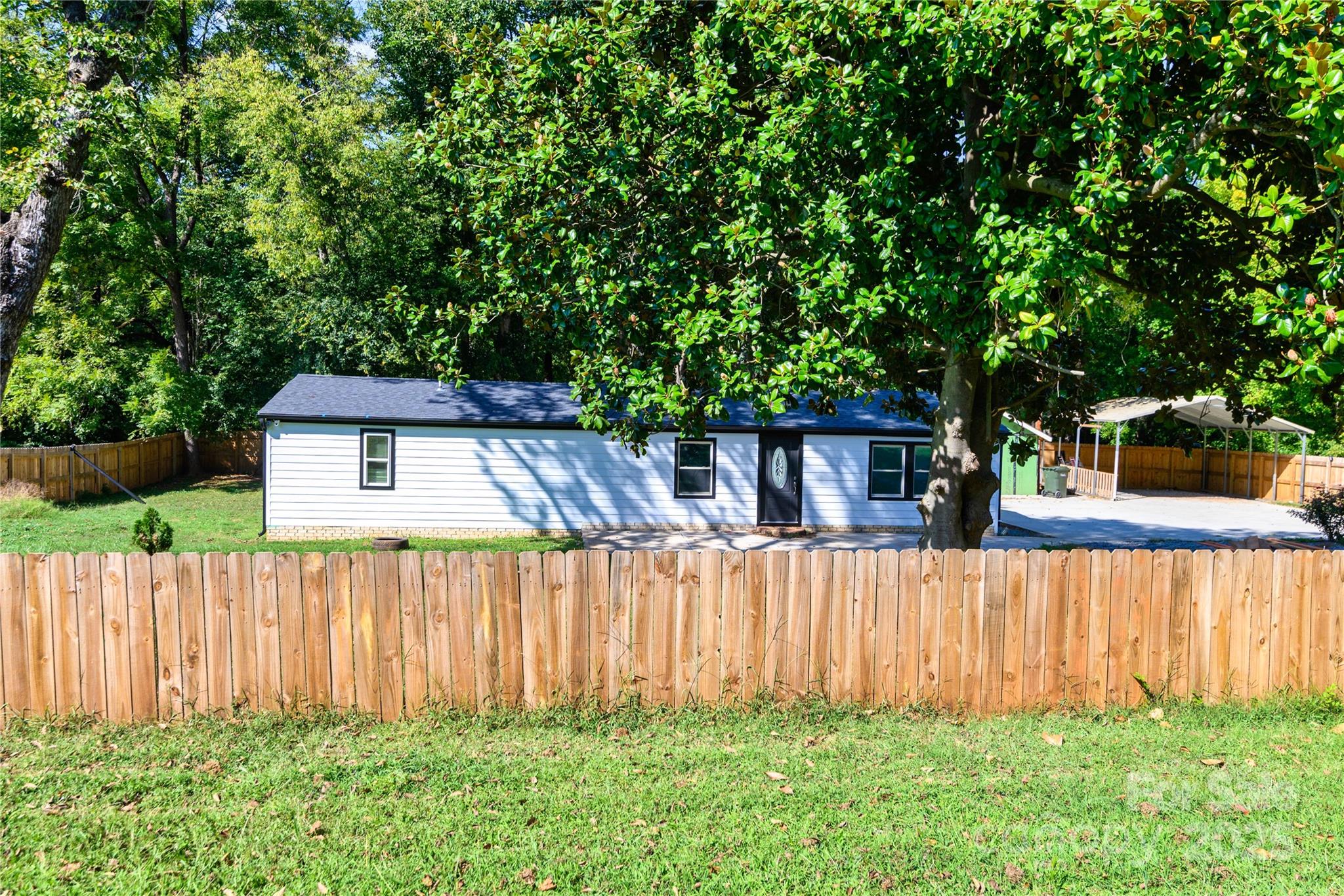 4946 Grand Canyon Road Northwest Concord, NC 28027 - Photo 10 of 40 a view of a backyard with wooden fence and plants