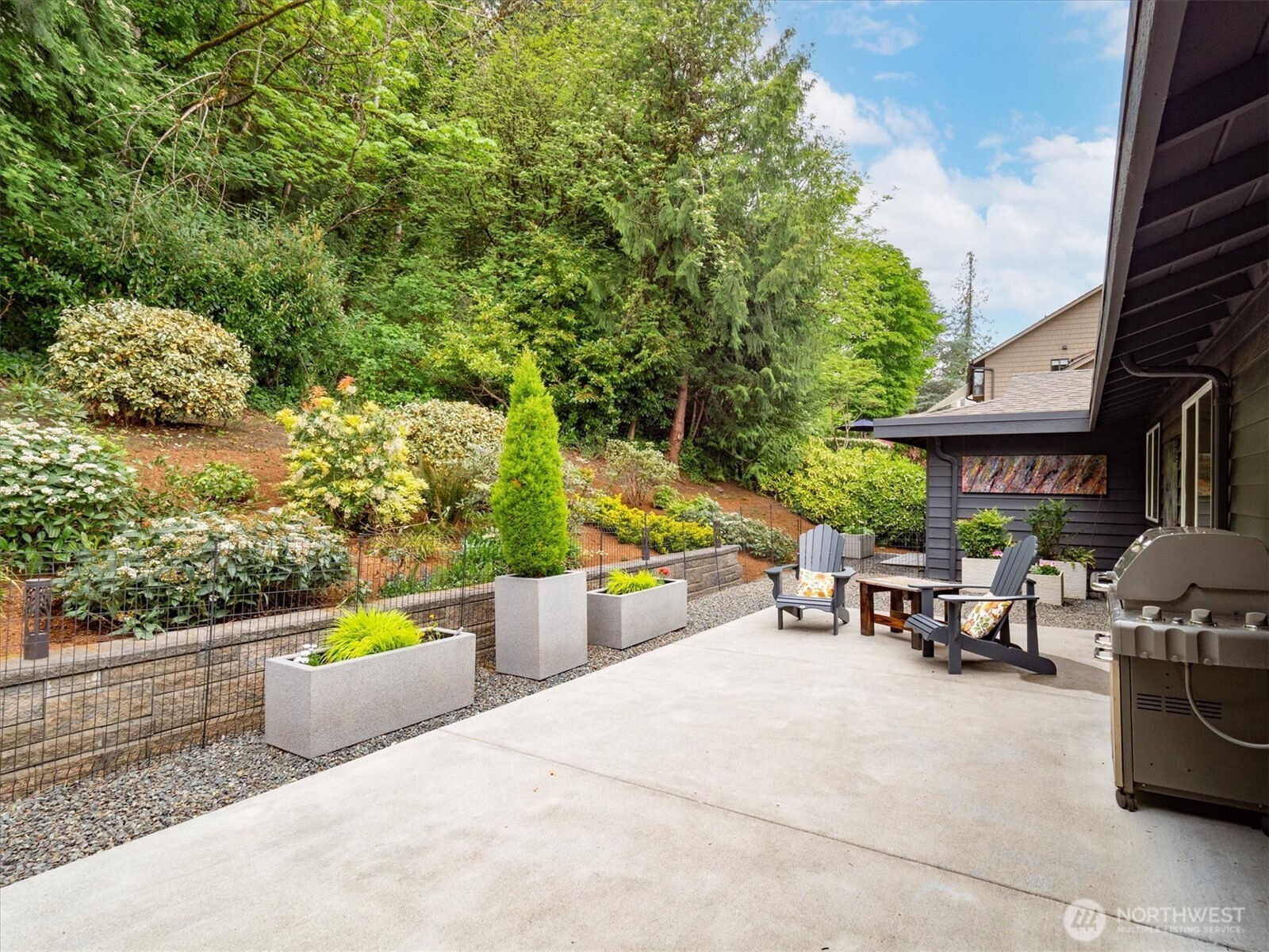 9503 Odin Way Bothell, WA 98011 - Photo 19 of 39 a view of a patio with couches and table and chairs and potted plants
