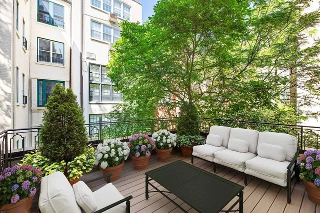 a view of a walk in closet with clothes and shoes
