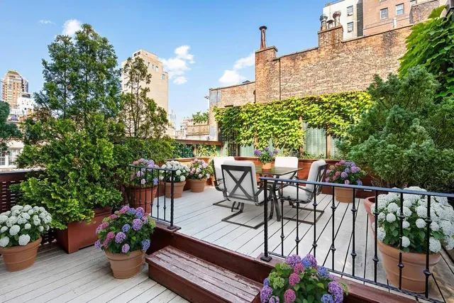 a kitchen with stainless steel appliances kitchen island granite countertop a refrigerator and wooden cabinets