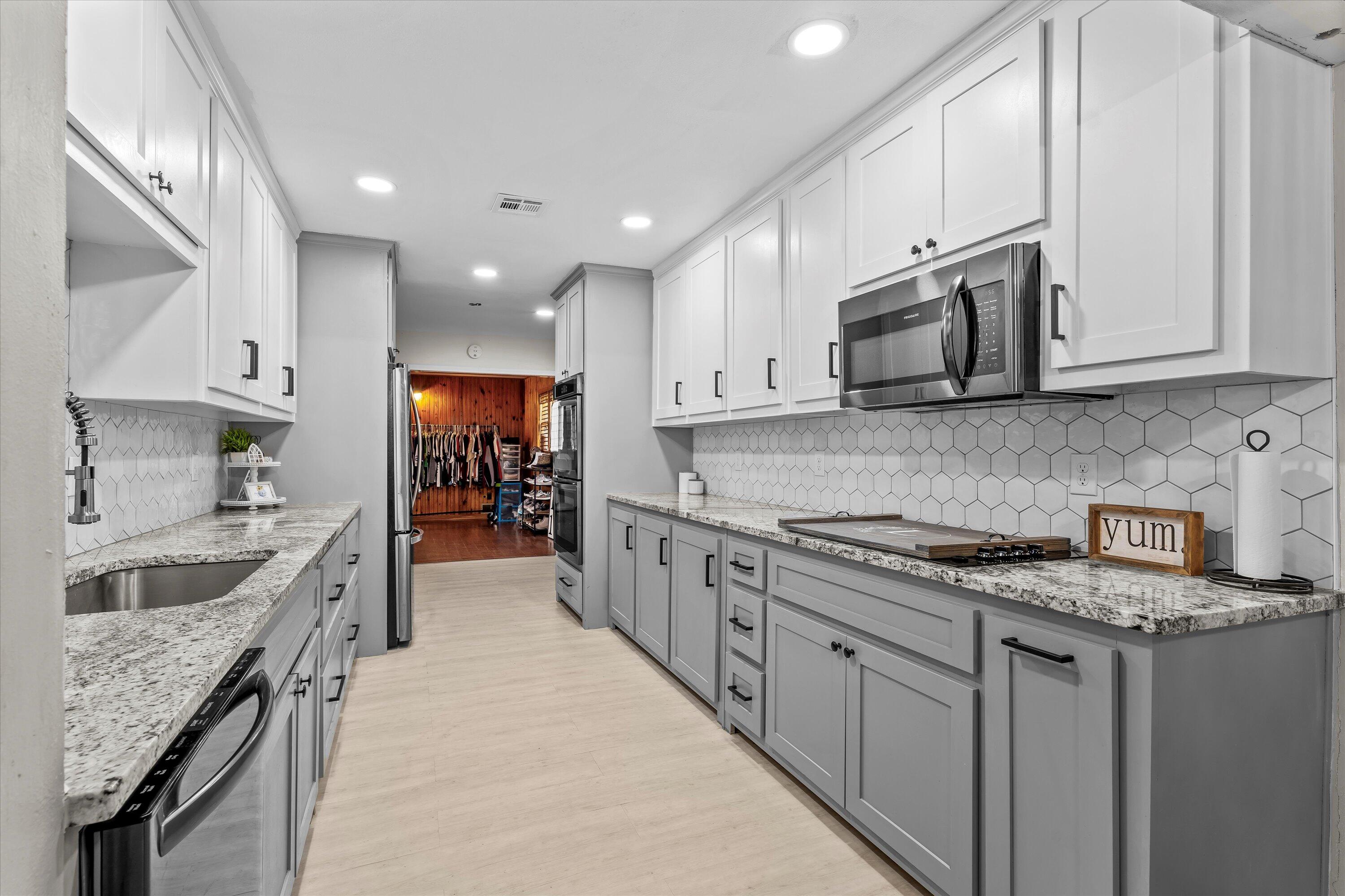 1601 Smith Street Littlefield, TX 79339 - Photo 11 of 32 a large kitchen with stainless steel appliances granite countertop a stove sink and cabinets