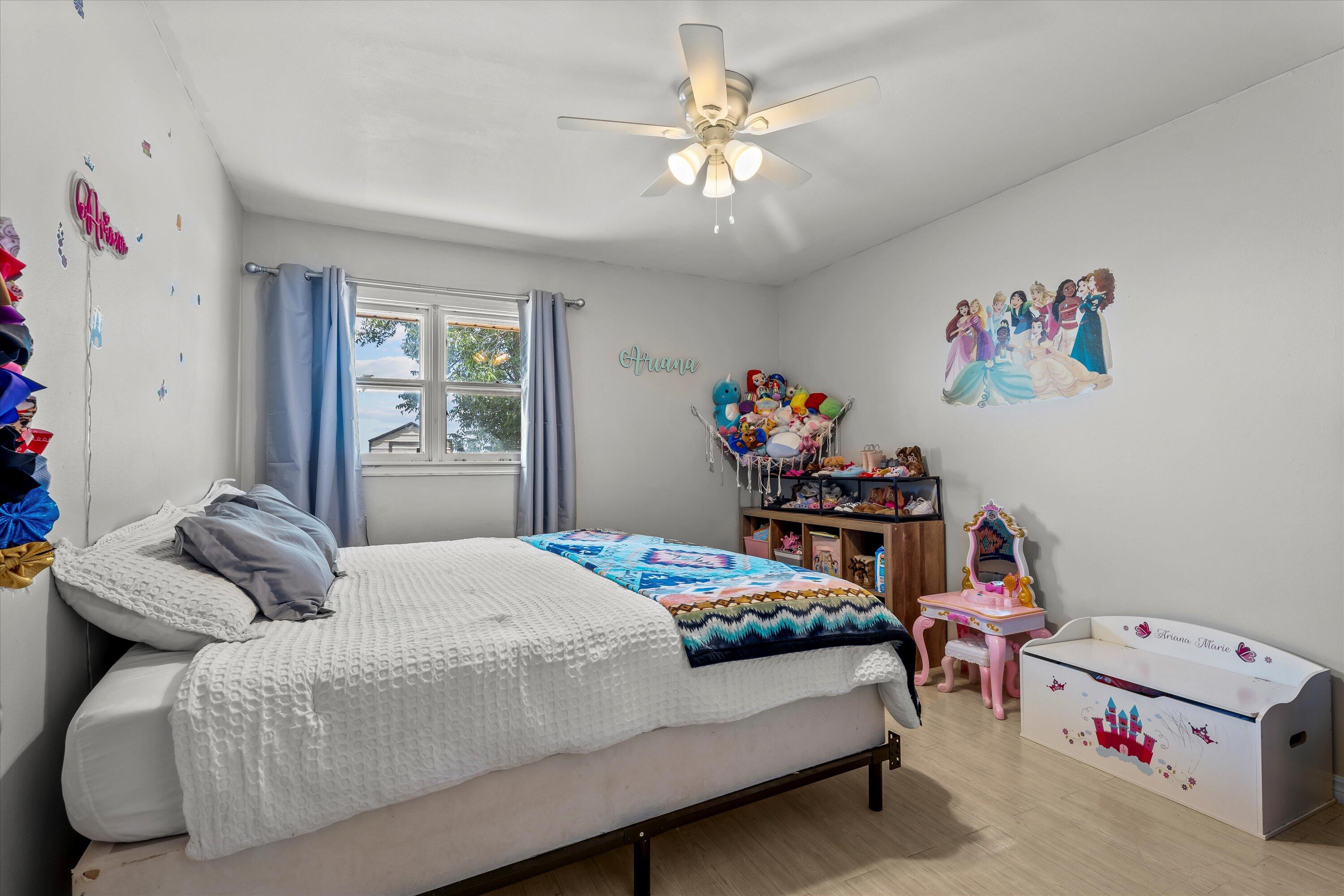 1601 Smith Street Littlefield, TX 79339 - Photo 15 of 32 a bedroom with a bed and a chandelier