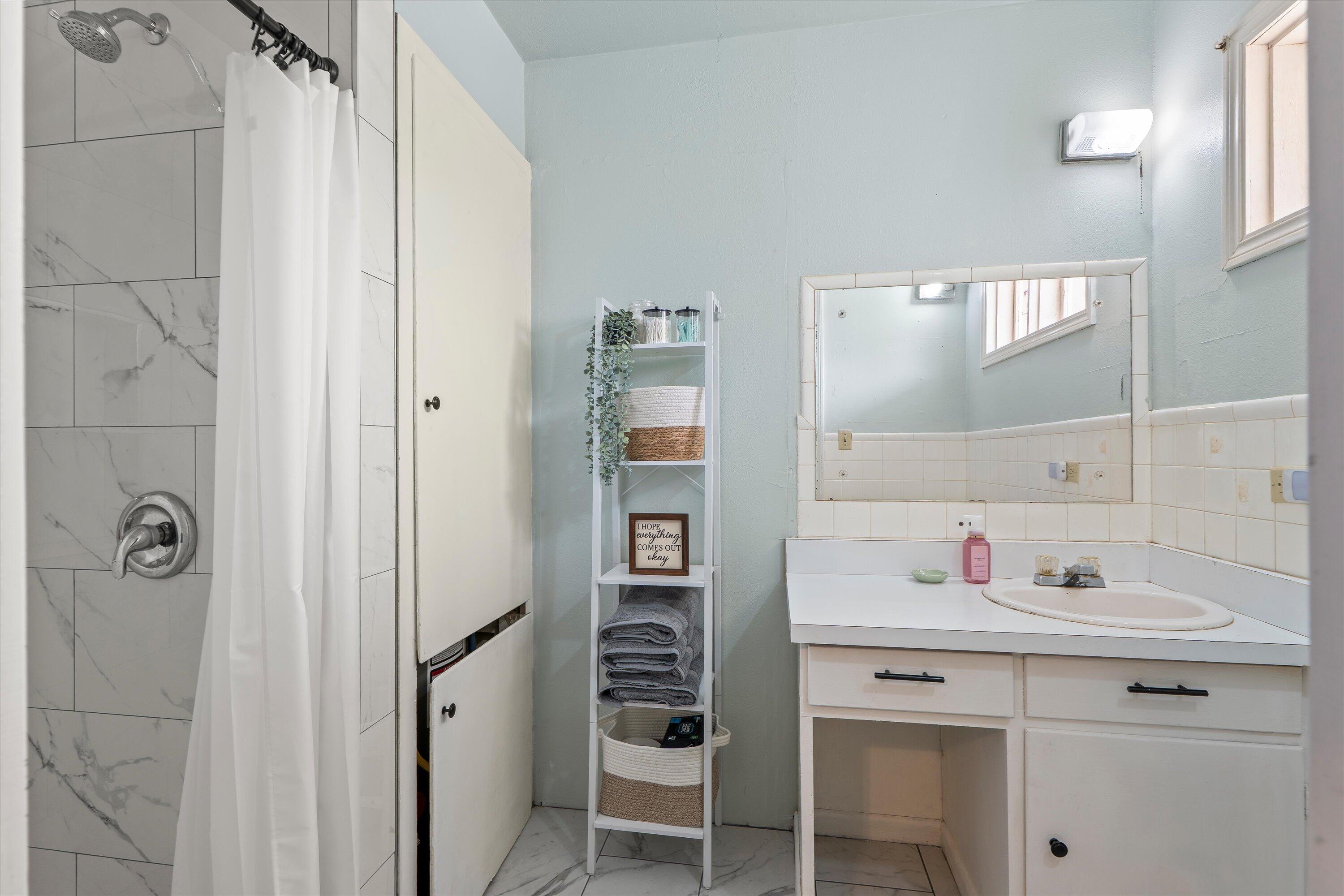 1601 Smith Street Littlefield, TX 79339 - Photo 23 of 32 a bathroom with a sink and a mirror