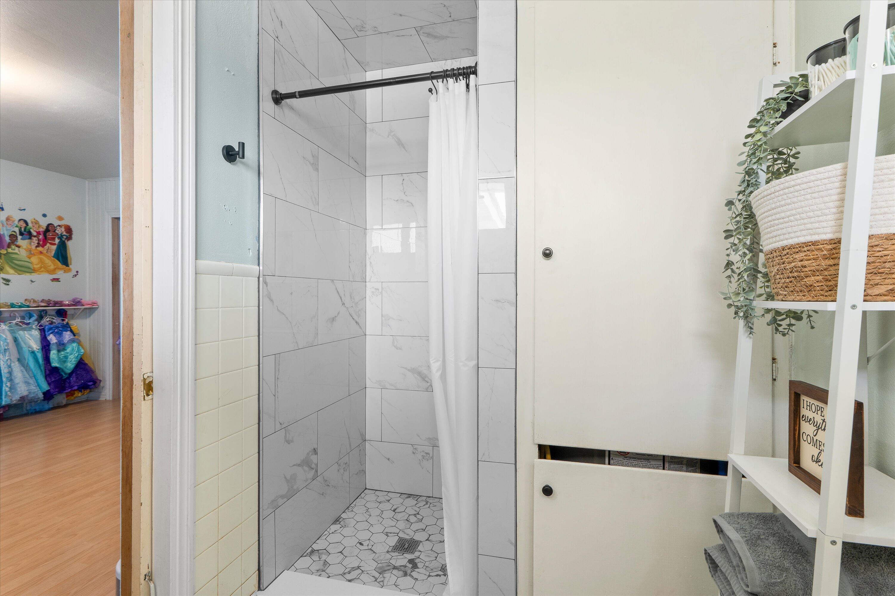 1601 Smith Street Littlefield, TX 79339 - Photo 24 of 32 a bathroom with a shower and a sink