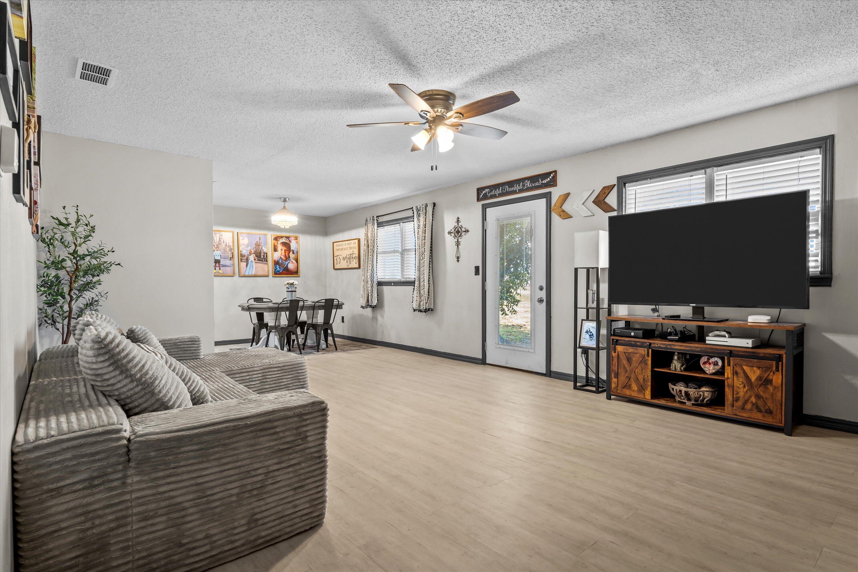 1601 Smith Street Littlefield, TX 79339 - Photo 5 of 32 a living room with furniture and a flat screen tv