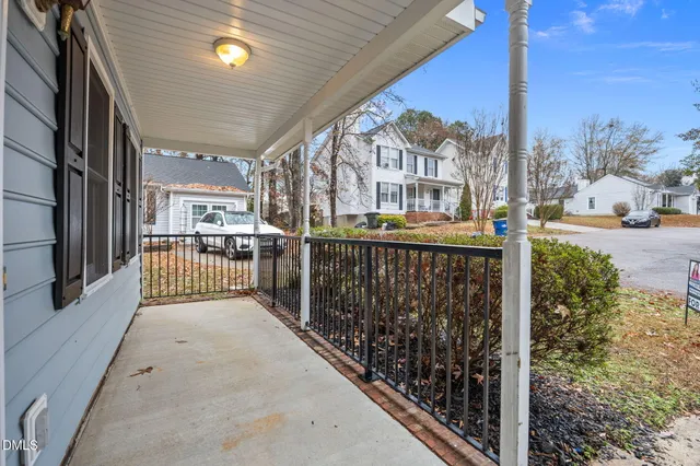 a view of a porch with a floor to ceiling window and a tree