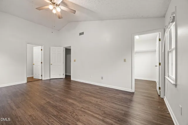 a view of an empty room with wooden floor